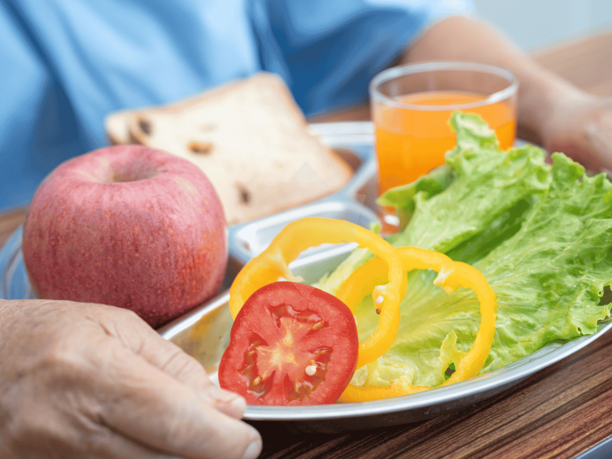 Caregiver and senior sharing a meal during a companion care visit at home
