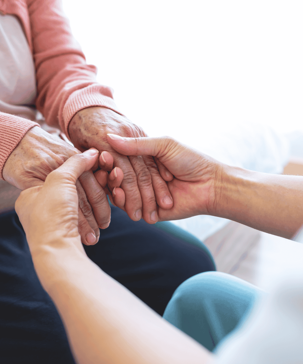 Caregiver looking through a photo album with a senior during in-home memory care